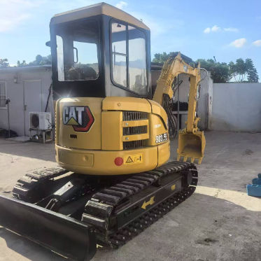 Использованный экскаватор Caterpillar 303.5E, оригинальная краска, основные компоненты не повреждены.